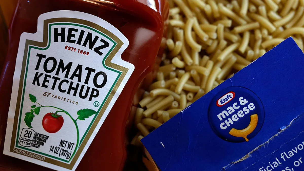 A bottle of Heinz tomato ketchup is displayed next to a box of Kraft Mac & Cheese