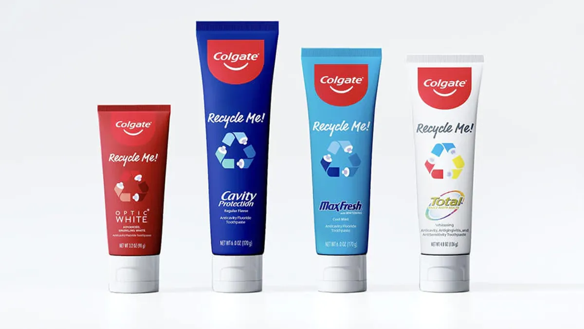 Four different colored tubes of Colgate toothpaste with the message "Recycle Me!" printed on the tubes.