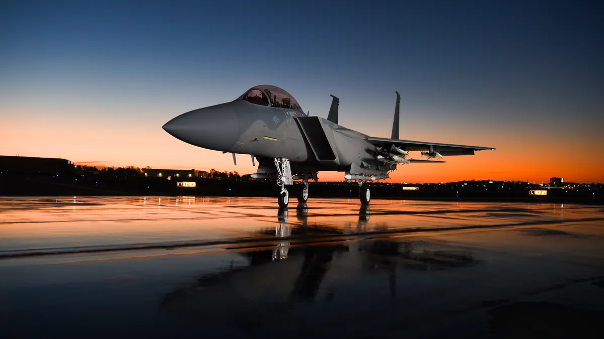 A grounded jet with a sunrise behind it.