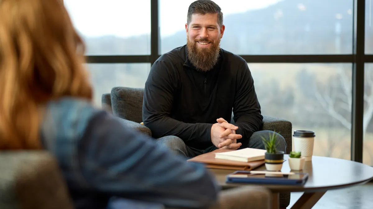 A man and a women having a meeting in a lounge.