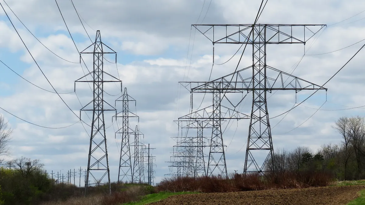Transmission lines run through a field.
