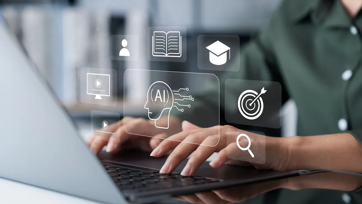 A person types on a laptop as an AI graphic hovers above the keyboard.