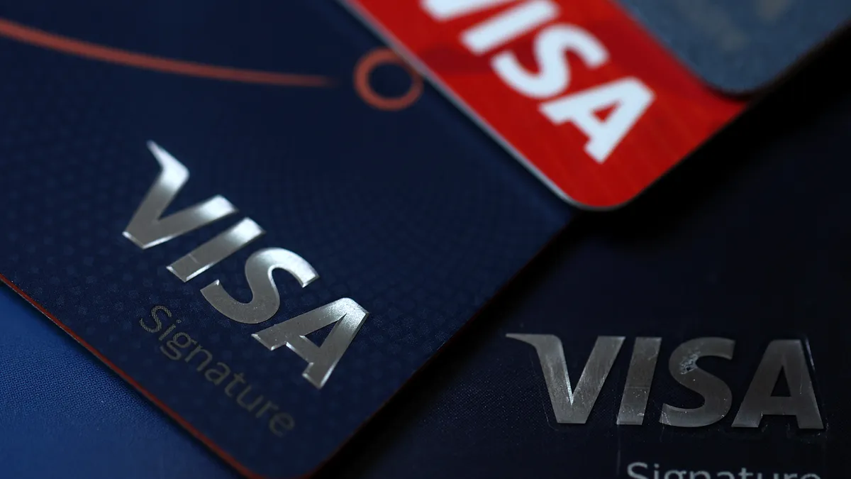 Several Visa credit cards displayed on flat surface