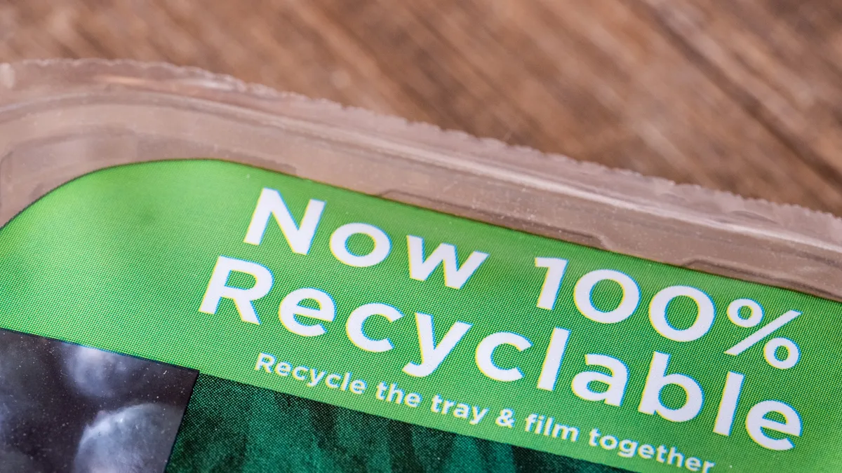 Close-up shot of a food container with film that says recyclable.