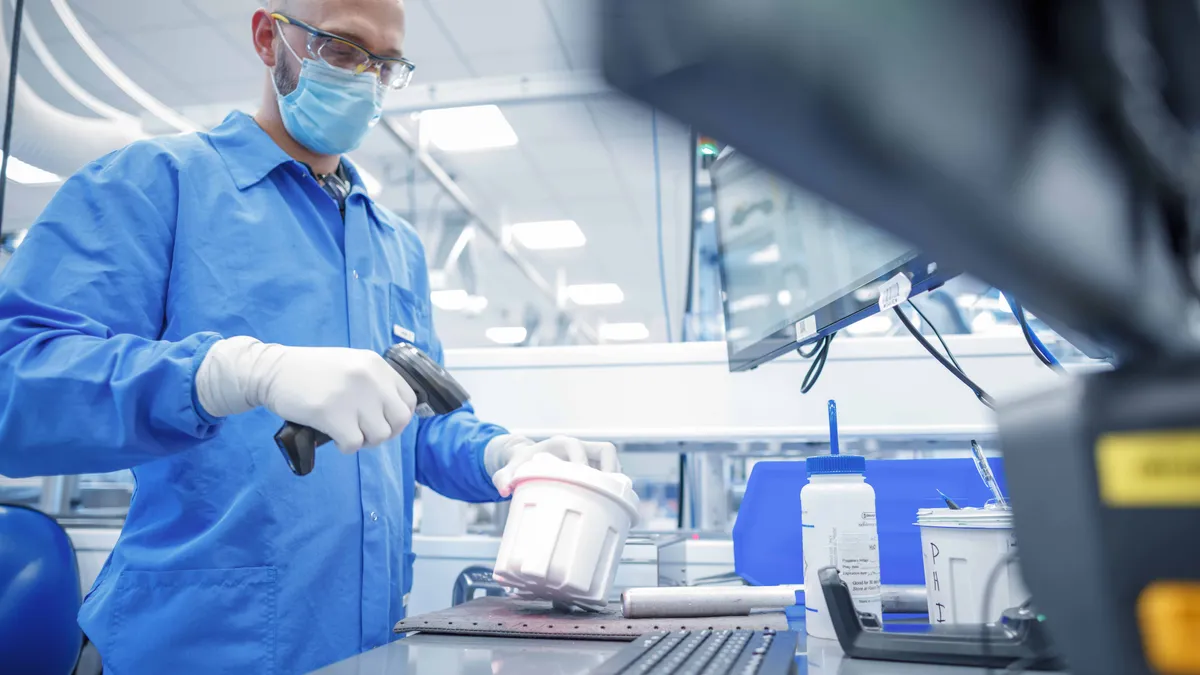 Senior Research Associate Tanya Quint loads one of the instruments used to run Exact Sciences' Cologuard test at the company's headquarters in Madison, Wis. (Photo: Business Wire)