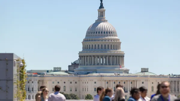 DC Climate Week attendees eat lunch with the Capitol in focus in the background