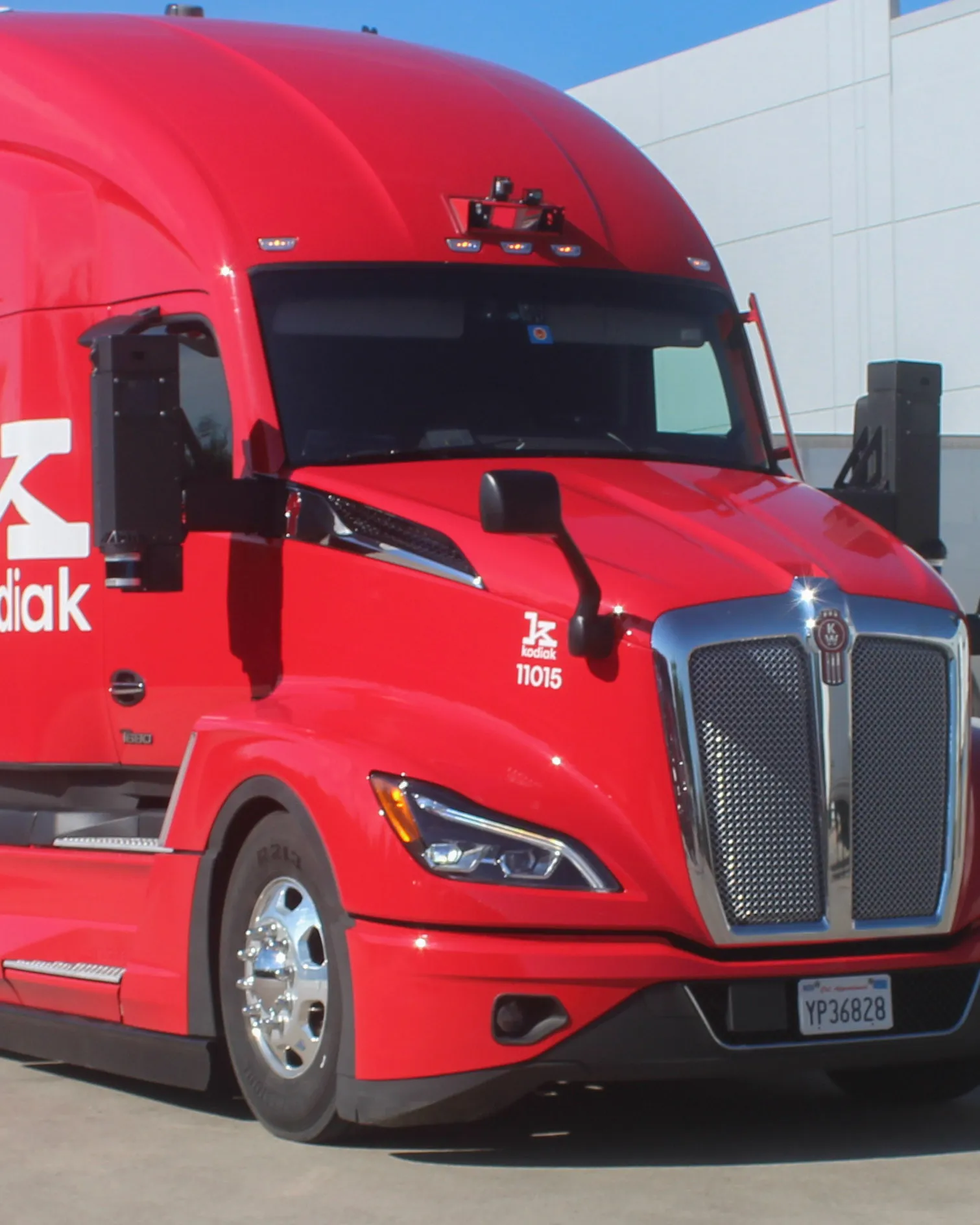 A close-up view of a Kodiak truck, showing its mirror-mounted sensors.