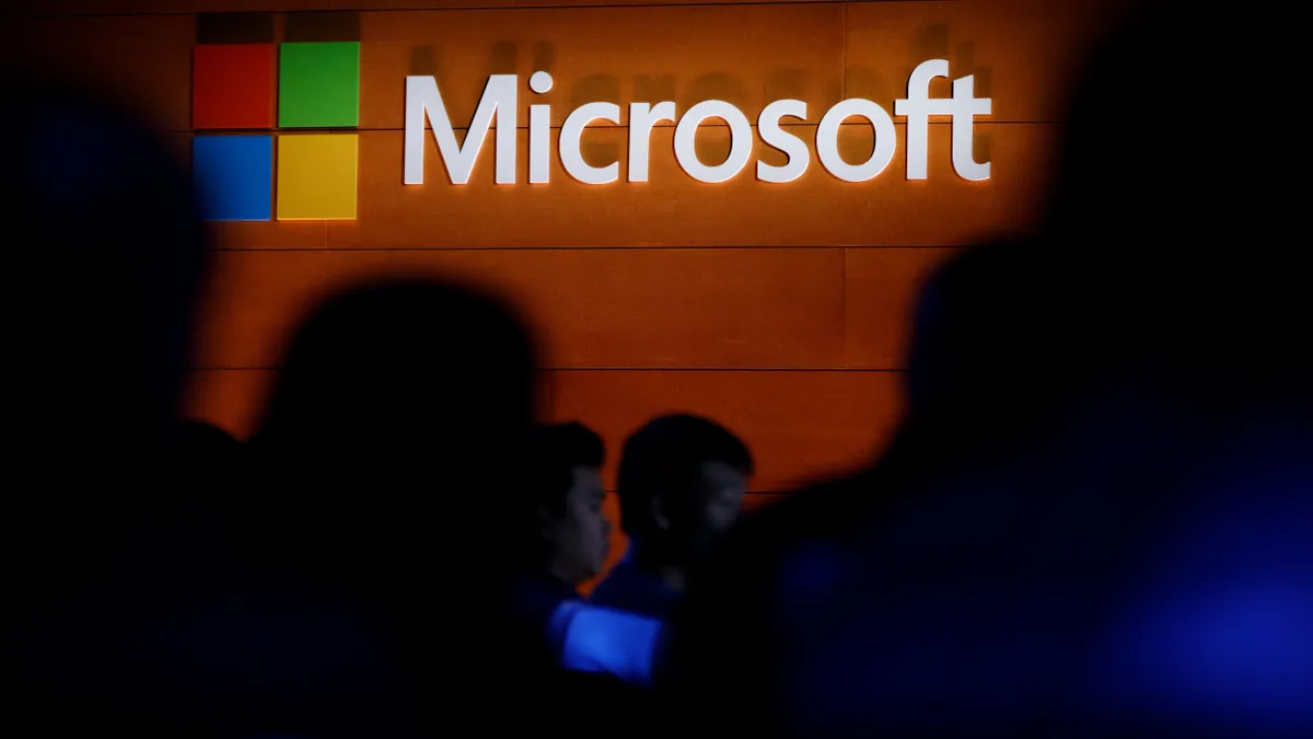 The Microsoft logo is illuminated on a wall during a Microsoft launch event to introduce the new Microsoft Surface laptop and Windows 10 S operating system, May 2, 2017 in New York City.