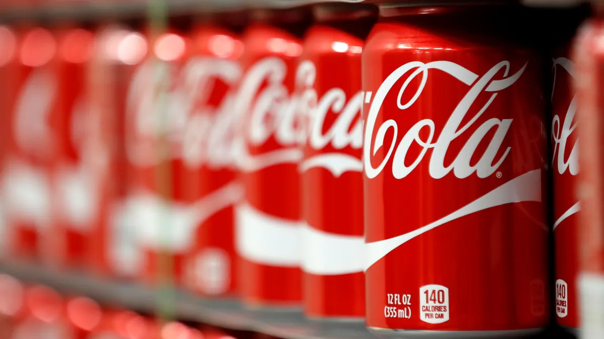 Coca-Cola cans on a pallet.