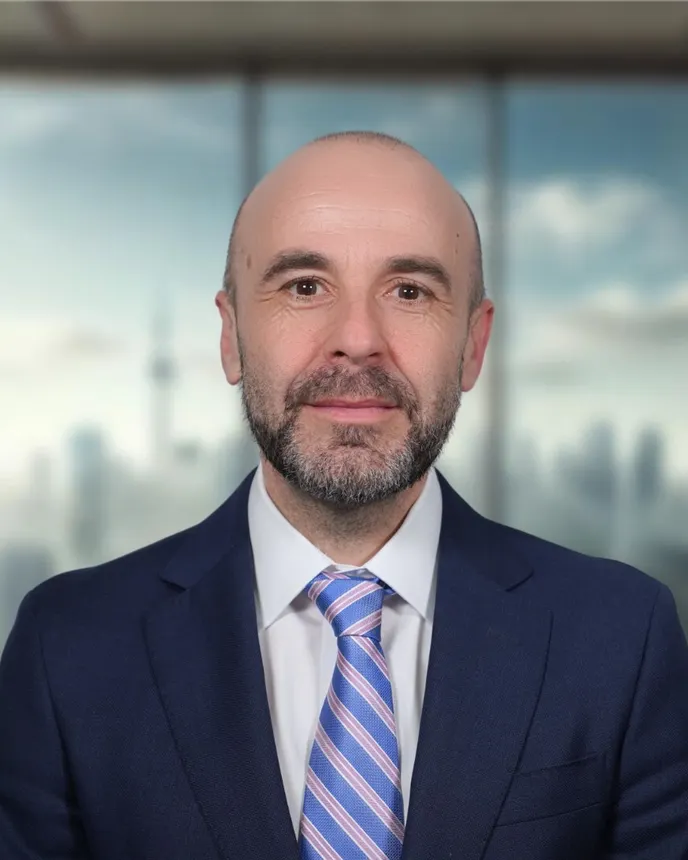 Headshot of a man in a suit.
