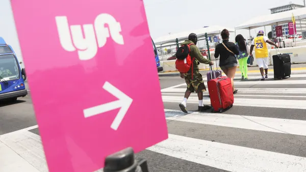 Air travelers walk toward a Lyft pickup area at Los Angeles International Airport (LAX) on August 20, 2020 in Los Angeles, California.