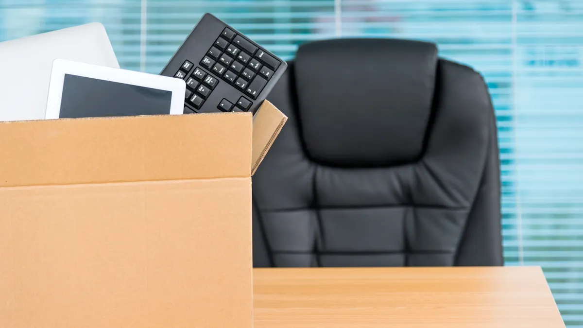 A box holding a keyboard sits in front of an office chair.