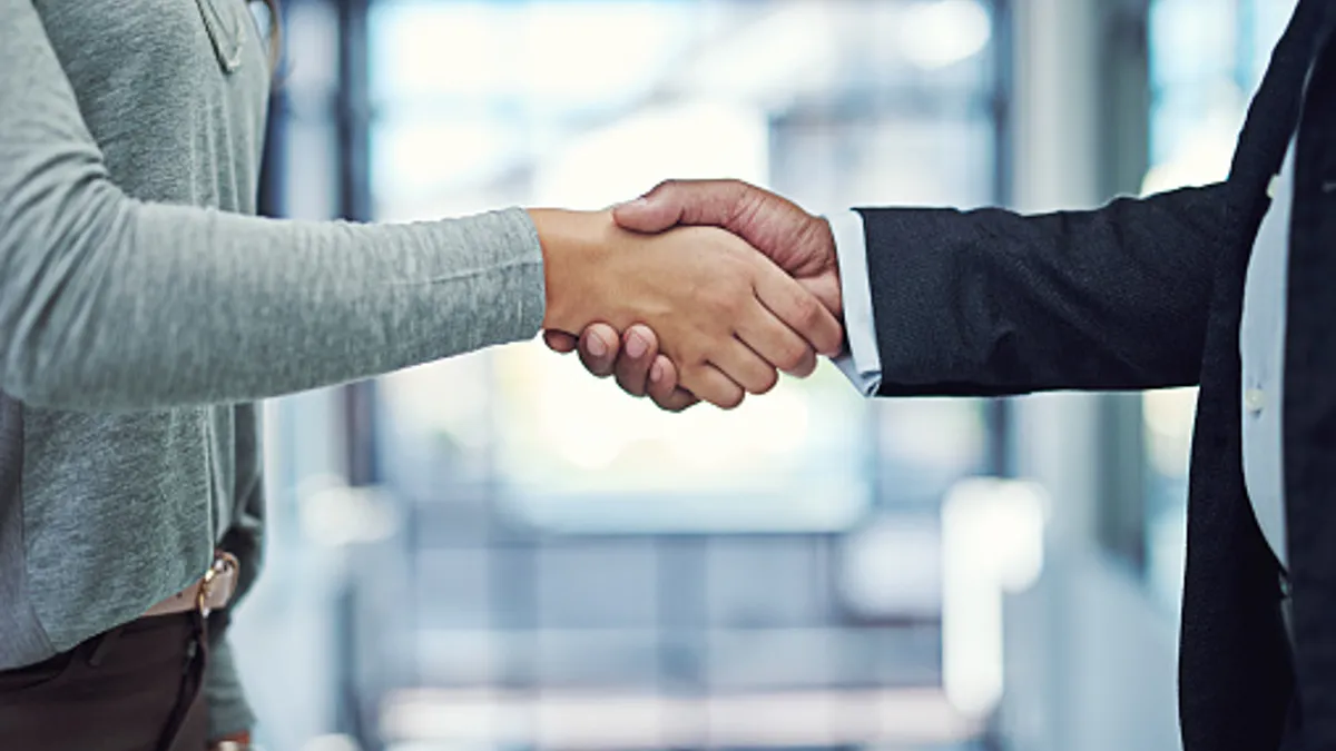 Close up shot of a handshake between two people