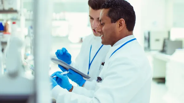 Two people looking at results in a lab.