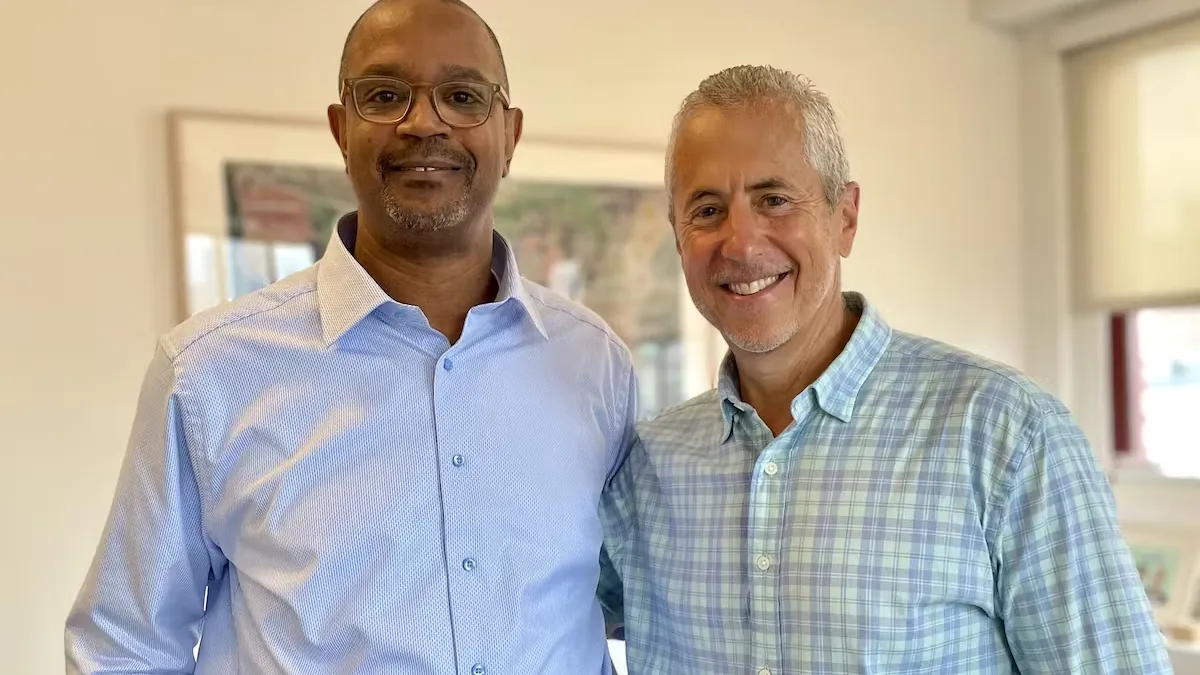 Two smiling men standing together