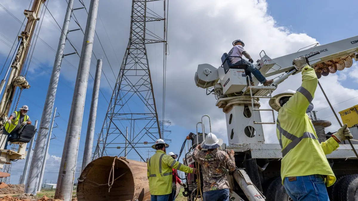 Service technicians work to install the foundation for a transmission tower at the CenterPoint Energy power plant