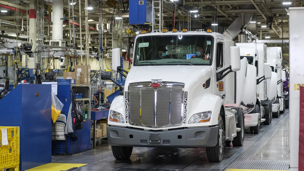 Yellow’s Greg Dam drives Peterbilt’s 579 Day Cab off the assembly line in Denton, Texas.