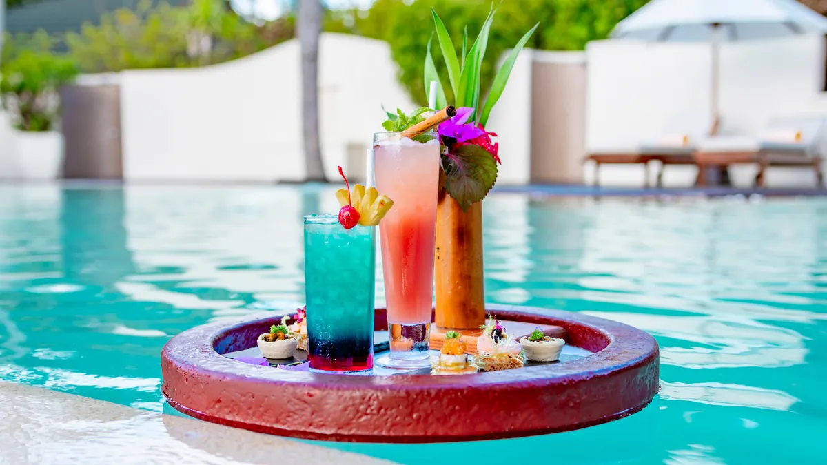Served floating tray in swimming pool with drinks and snacks on tropical island resort