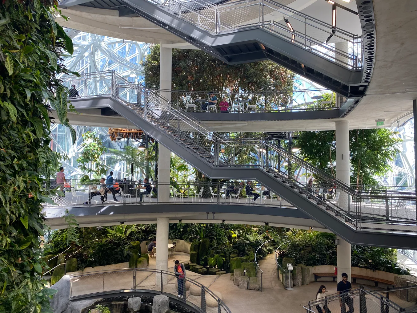 An open atrium filled with plants with stars crossing open floors.