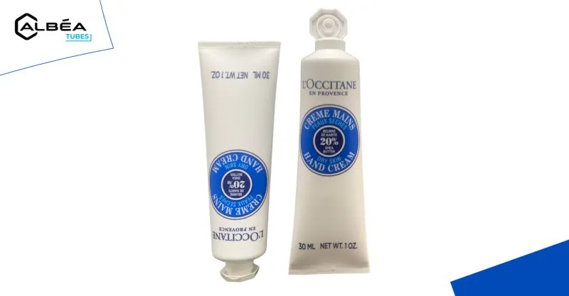 Two plastic tubes of L'Occitane hand cream.