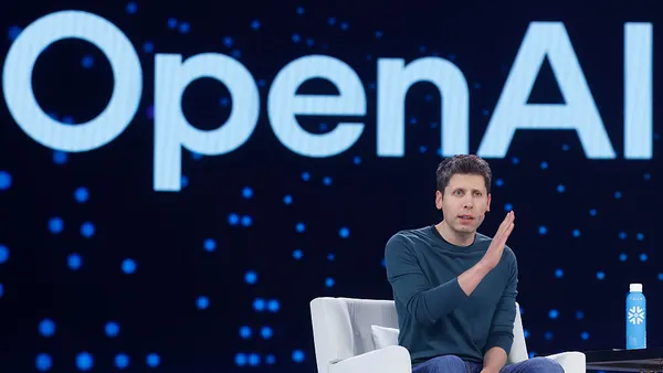 Sam Altman speaks in a conference setting