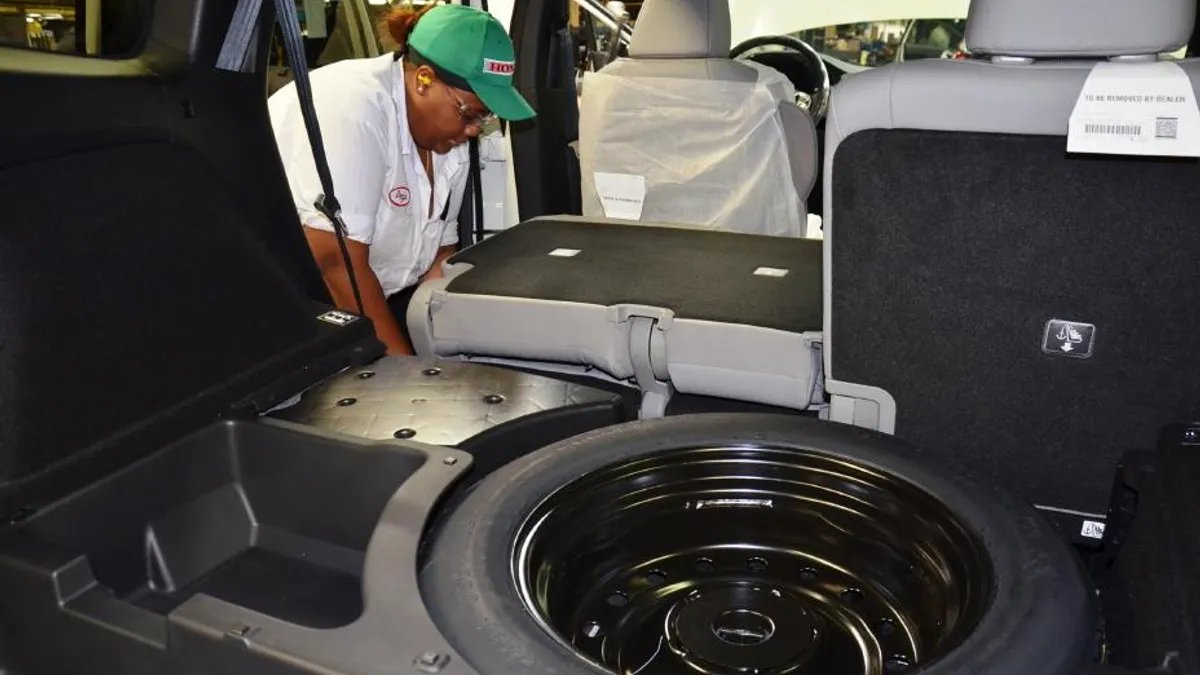 A Honda Manufacturing of Alabama associate installs the back seat in the all-new 2019 Honda Passport.