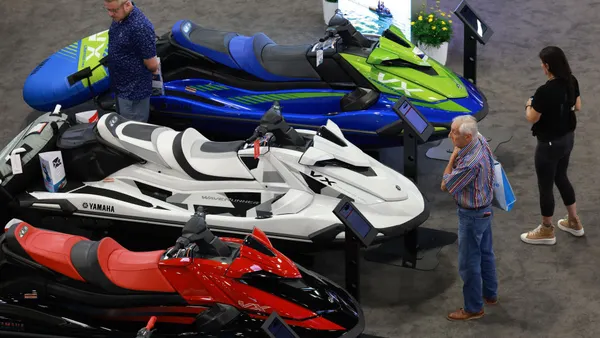 People look at Yamaha watercraft on display at a Miami Beach, Florida, boat show.