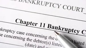A Chapter 11 bankruptcy court document, with a pen under the word "bankruptcy."