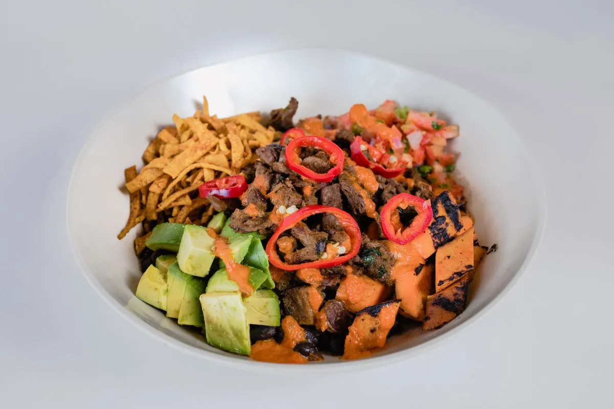 Veggie Grill menu item in a while bowl with plant-based protein and various vegetables