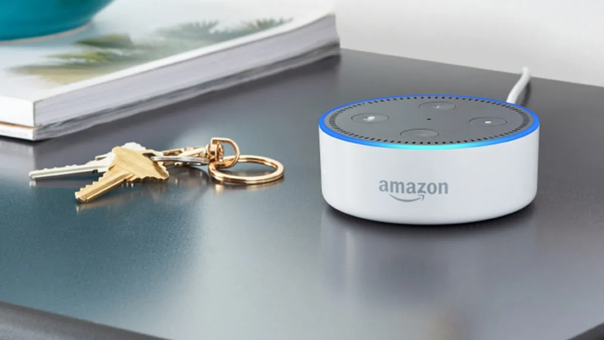 An Amazon Echo sits on a table next to a set of keys.