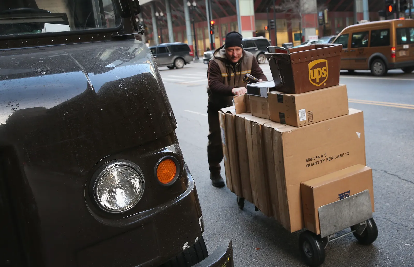 A UPS worker delivers packages on December 26, 2013 in Chicago, Illinois.