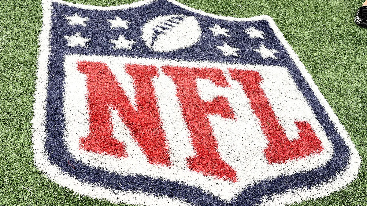 The NFL shield logo is painted onto the field at Cowboys Stadium in 2010.