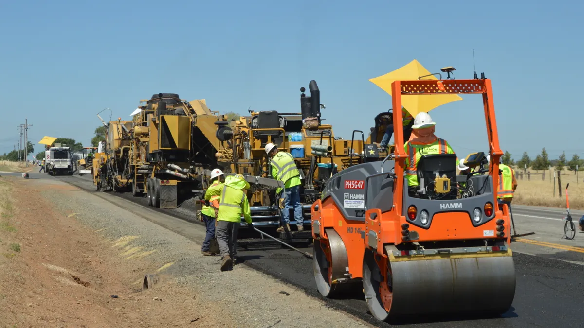 Caltrans workers lay down recycled asphalt that uses a binding agent made from old plastic bottles on Highway 162.