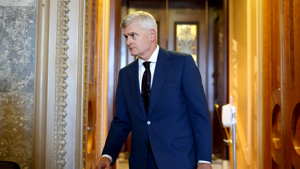 Senator Bill Cassidy walks out of the Senate chamber.