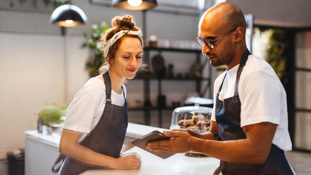 Two people talking in a kitchen