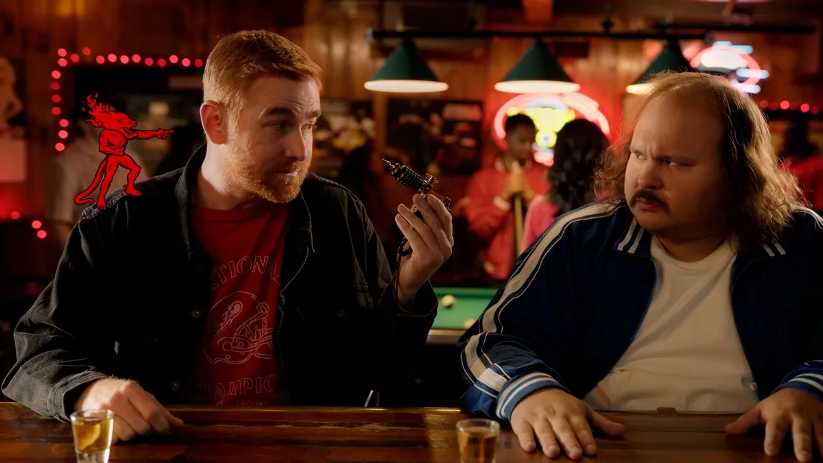 Comedians Andrew Santino and Stavros Halkias appear side-by-side in a humorous ad promoting Fireball Cinnamon Whisky.