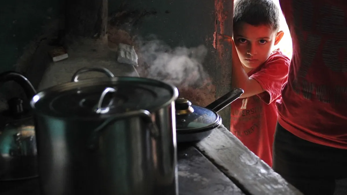 Kid peeking by a wall