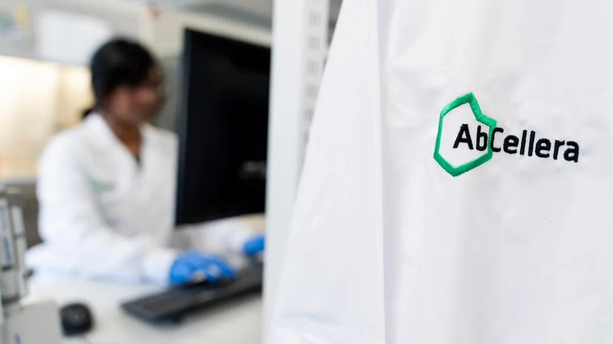 A white lab coat showing an AbCellera logo