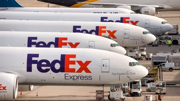 A line of FedEx aircraft sit at Cologne Bonn Airport in Germany.
