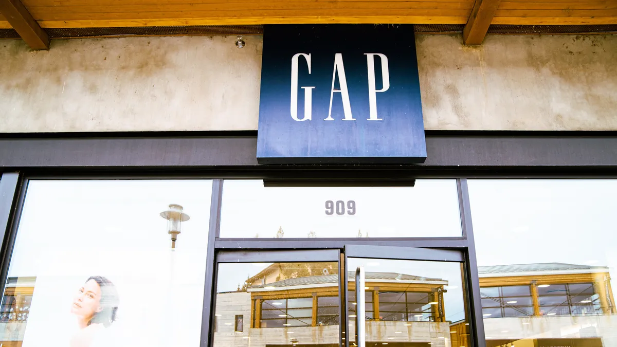 A store window, with a blue square square above that says "GAP" in white capital letters.