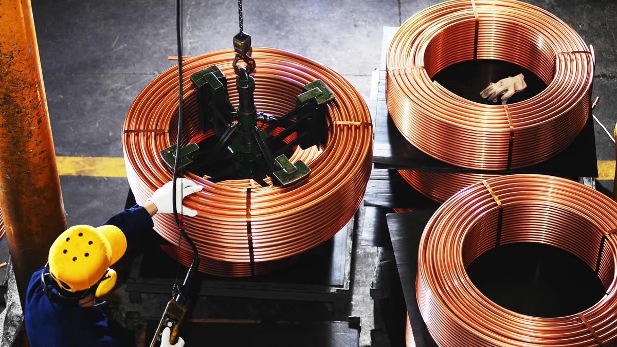 An overview of a worker testing copper coils.