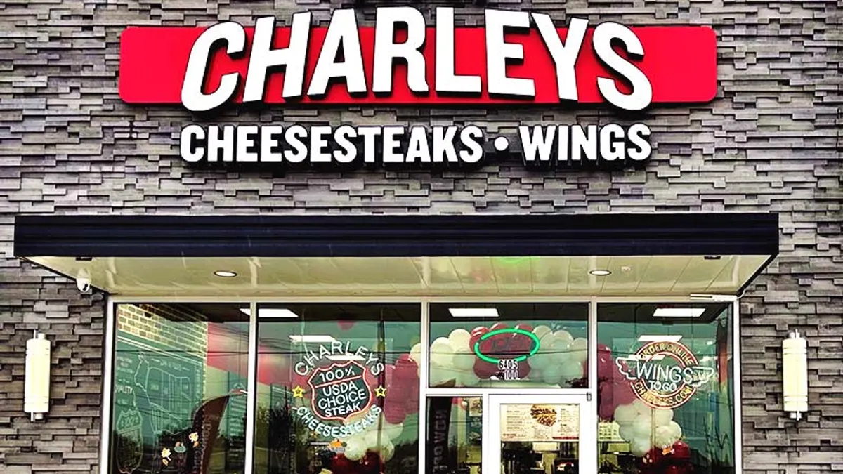 An image of a gray building with Charleys signage