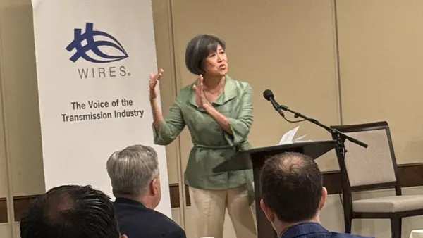 A woman speaking at a conference.