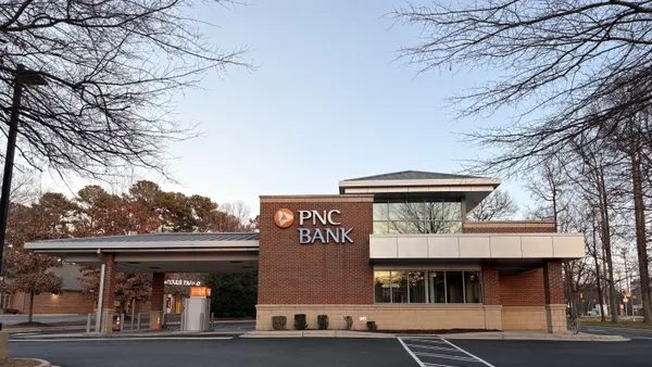 A brick and glass building is shown with the words "PNC Bank" and the PNC logo on the facade.