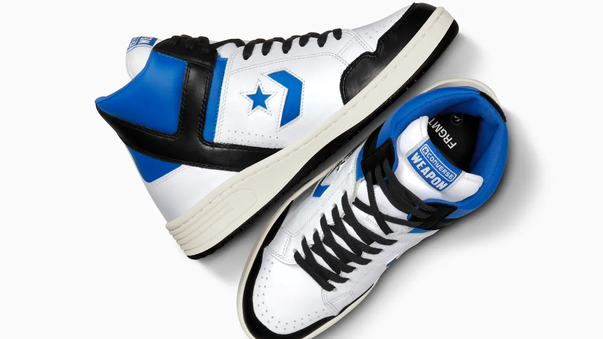 A pair of black, blue and white converse shoes on a white background