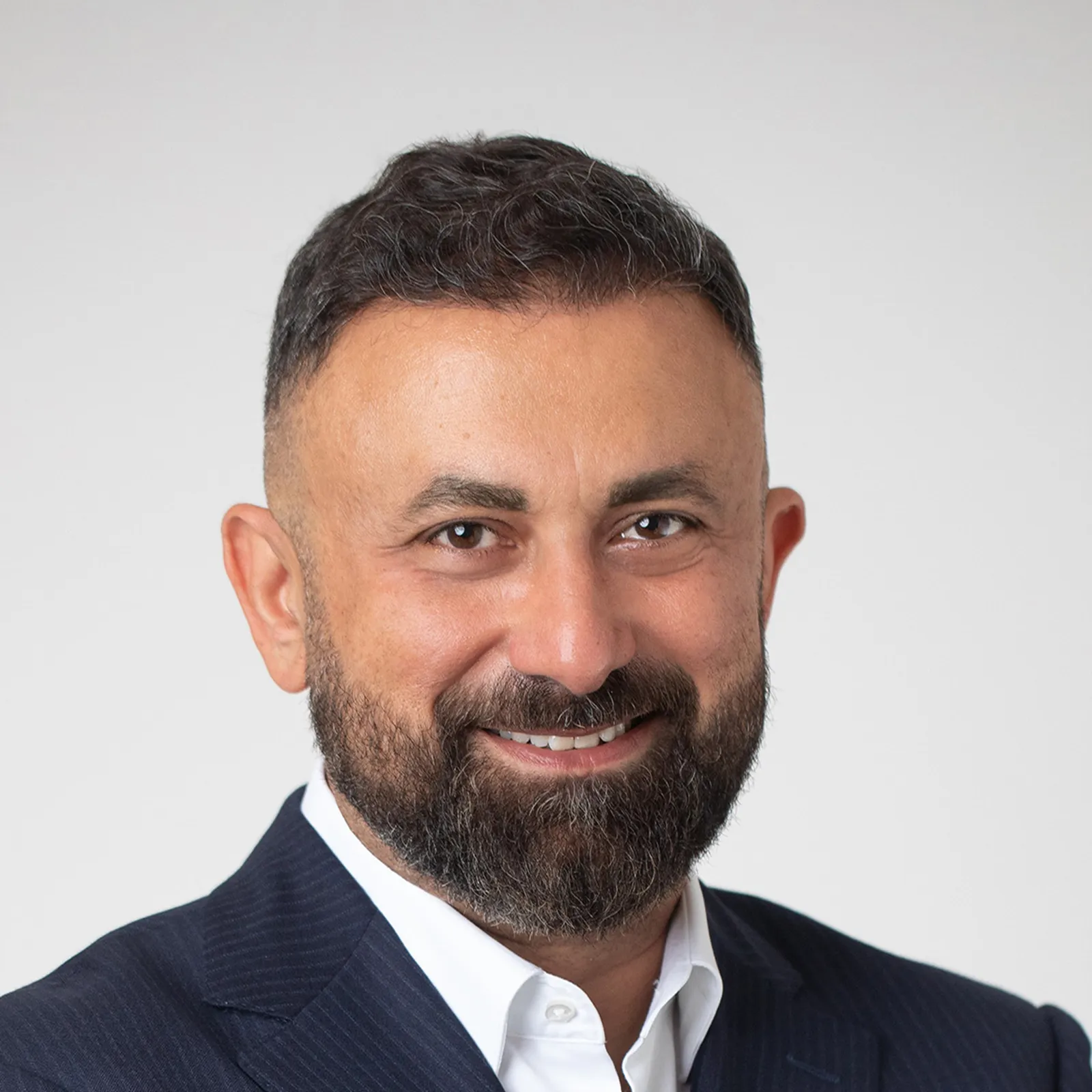 A headshot photograph of Ahmet Hepdogan, SVP of supply chain and procurement for North America for Dawn Foods