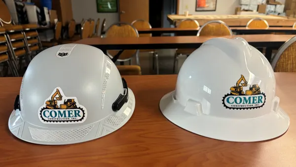 Two construction helmets on a table.