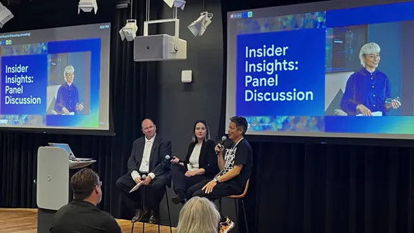 three people sit on a panel