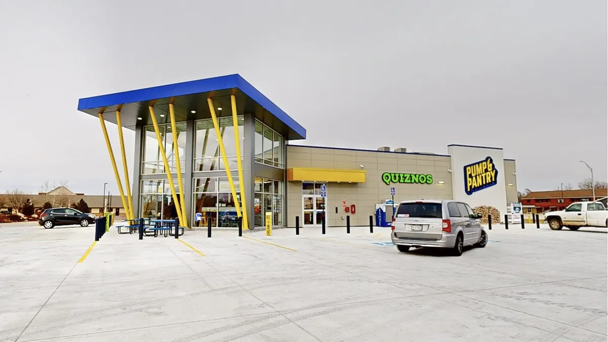 A photo of the exterior of a convenience store in Nebraska. The side of the building says "Quiznos" and "Pump & Pantry."