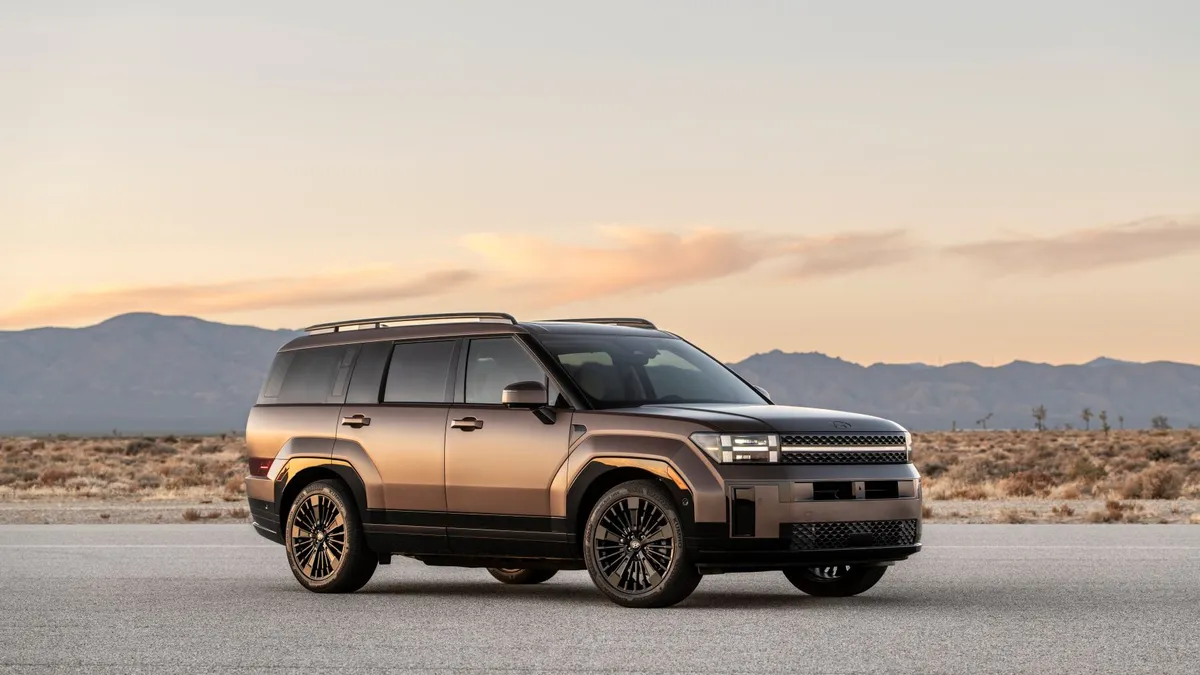 The 2024 Hyundai Santa Fe SUV in a desert setting with mountains in the background.